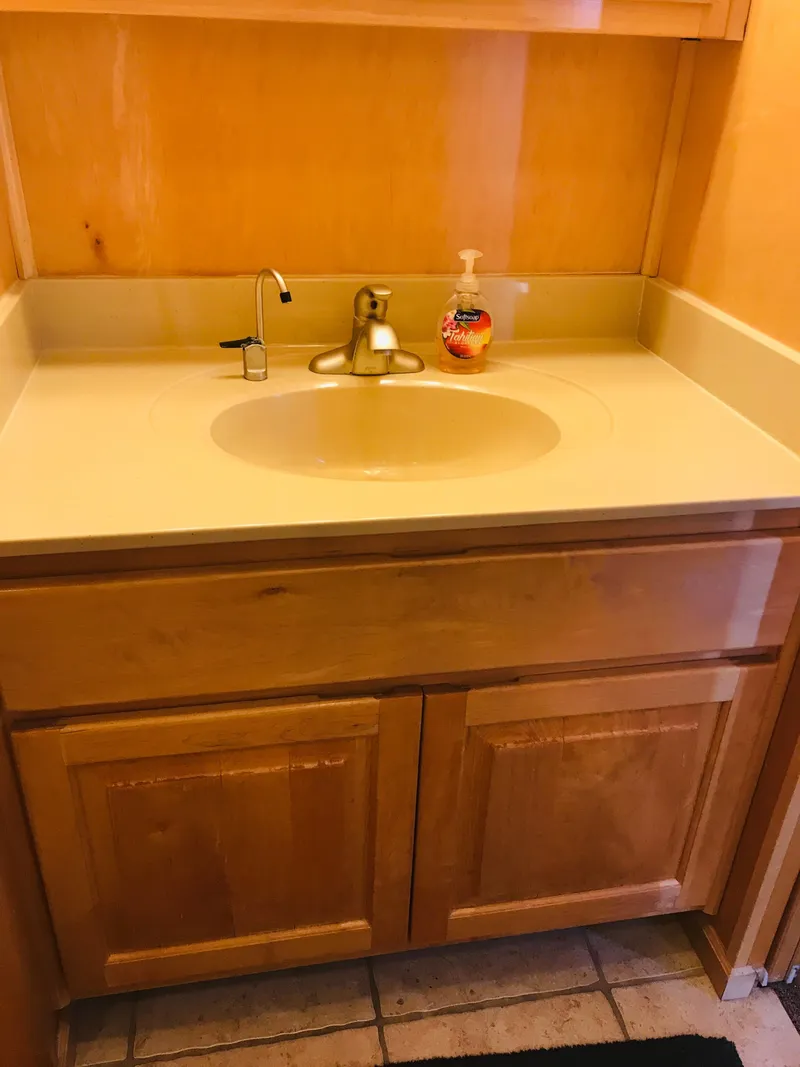 Slide: The Image of Wooden bathroom vanity with sink and soap dispenser, Stardust Cruisers 2005 model. - 22