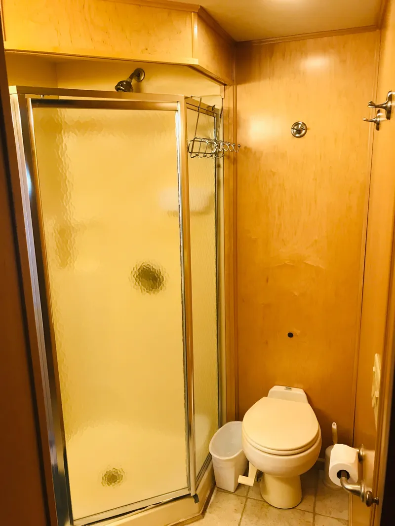 Slide: The Image of Bathroom interior of 2005 Stardust Cruisers Summer Obsession, featuring shower and toilet. - 24