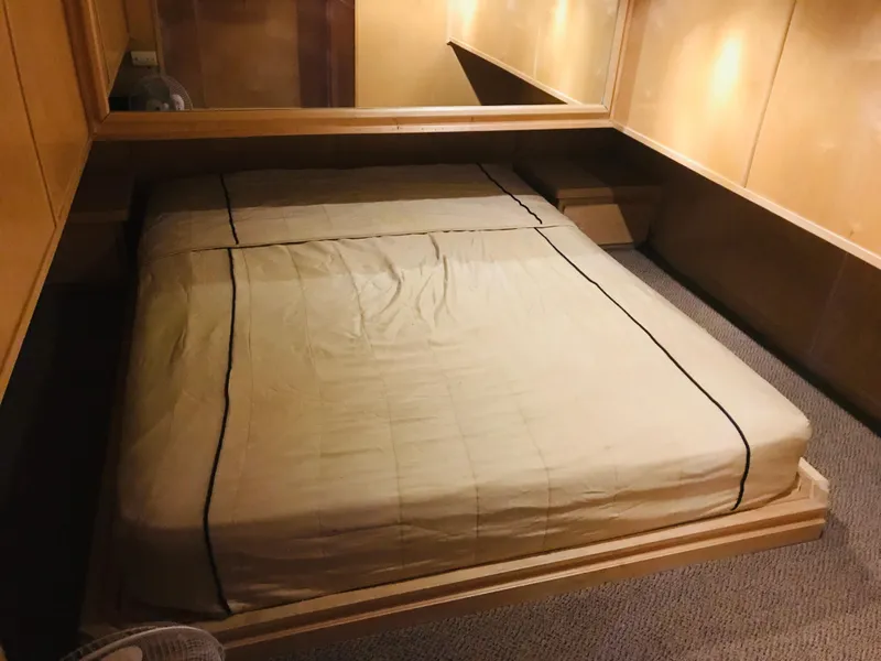 Slide: The Image of 2005 Stardust Cruisers Summer Obsession bedroom with beige bedding and wooden accents. - 25