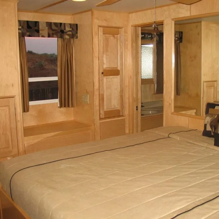 Slide: The Image of Interior of 2005 Stardust Cruisers Summer Obsession, featuring a cozy bedroom with wooden decor. - 26