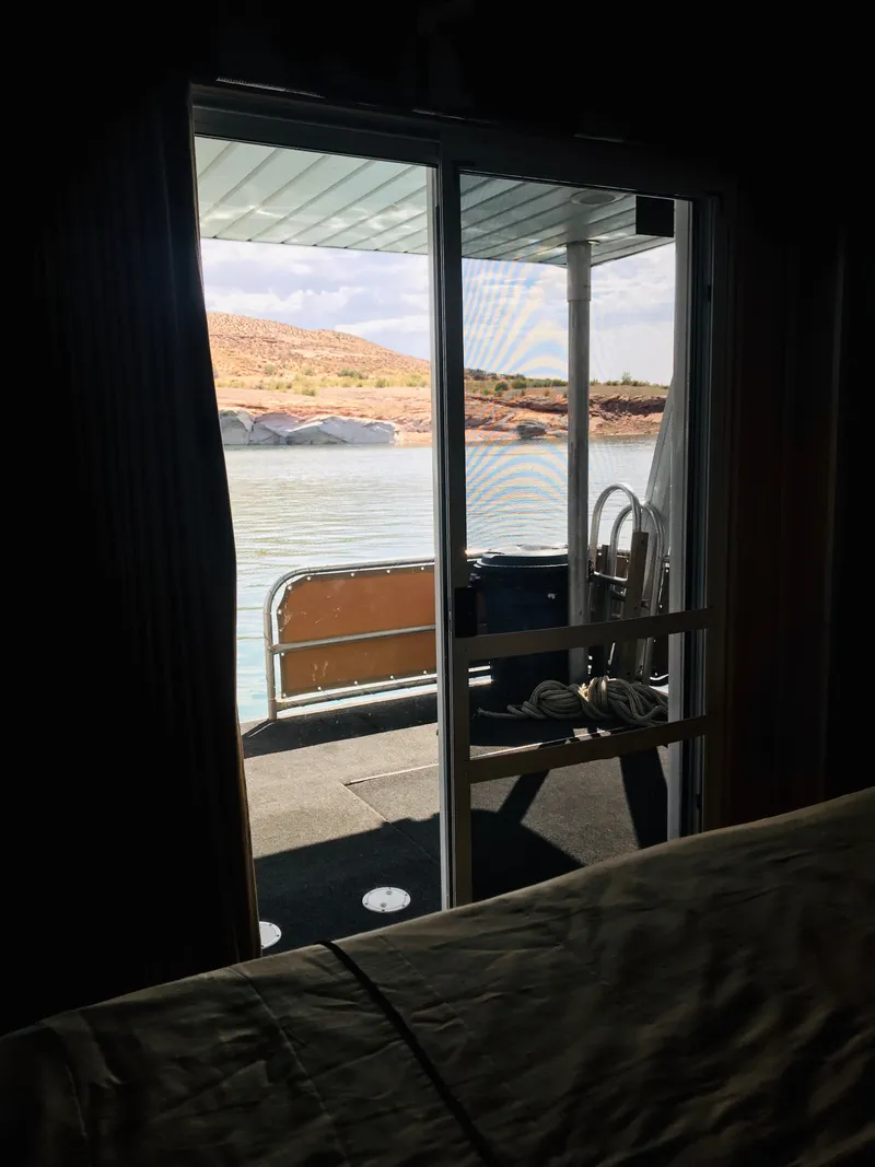 Slide: The Image of View from Stardust Cruisers 2005 houseboat, overlooking serene lake and distant hills. - 28