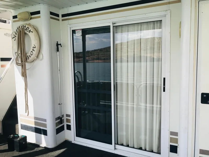 Slide: The Image of 2005 Stardust Cruisers Summer Obsession houseboat with sliding glass door and life preserver. - 35