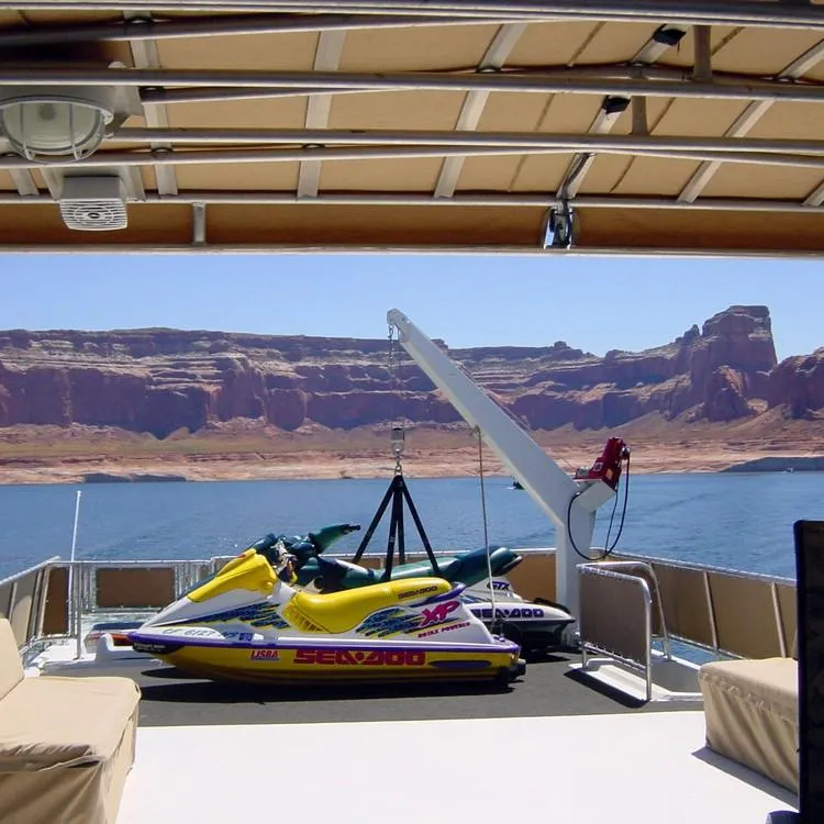 Slide: The Image of 2005 Stardust Cruisers houseboat with jet skis on deck, scenic lake and canyon backdrop. - 39