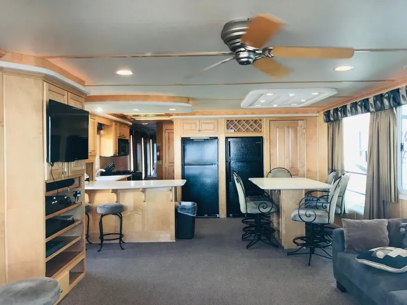 Slide: The Image of Interior of 2005 Stardust Cruisers Summer Obsession, featuring kitchen, dining area, and ceiling fan. - 4