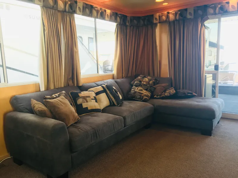Slide: The Image of Luxurious 2005 Stardust Cruisers houseboat interior with cozy sectional sofa and decorative pillows. - 5