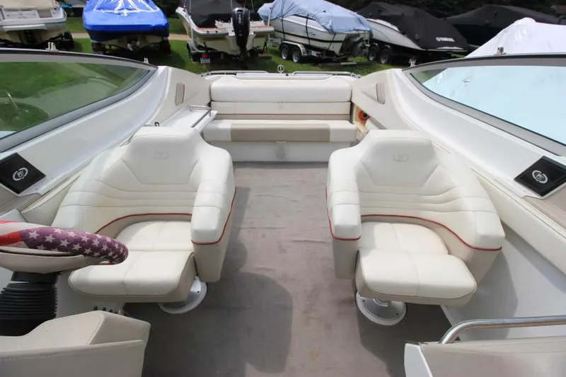 Slide: The Image of Interior of a 1997 Cobalt 272 BR boat with white leather seating. - 10