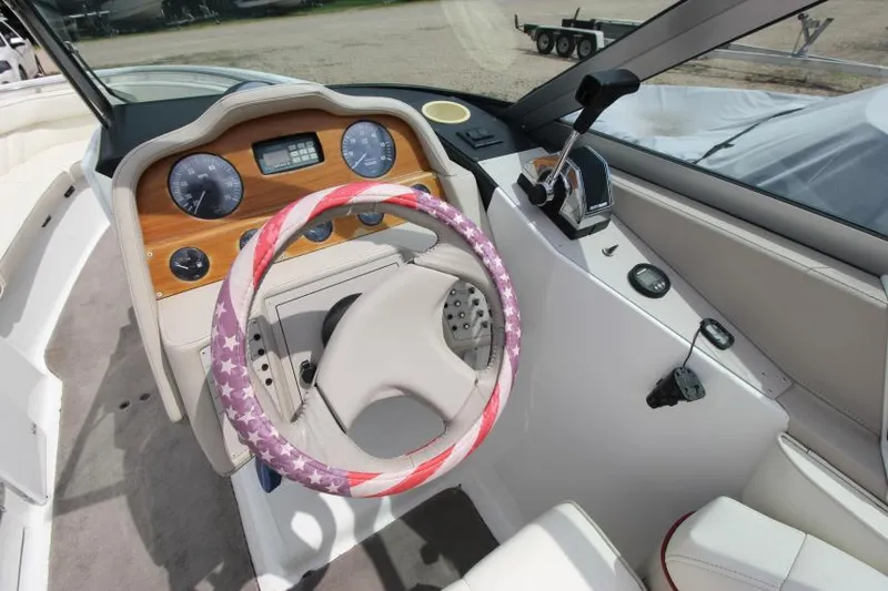 Slide: The Image of 1997 Cobalt 272 BR boat dashboard with patriotic steering wheel cover. - 14