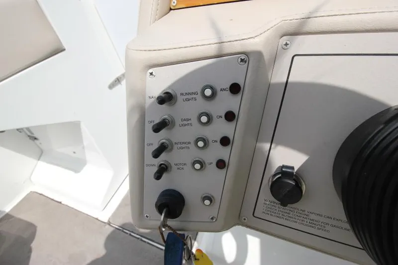 Slide: The Image of Control panel of a 1997 Cobalt 272 BR boat with switches and key ignition. - 16
