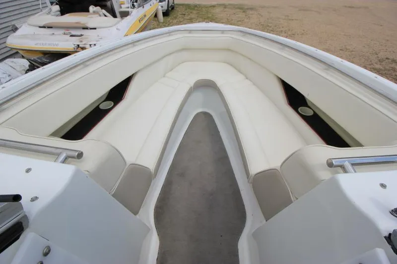 Slide: The Image of 1997 Cobalt 272 BR boat interior with white seating and carpeted floor. - 19
