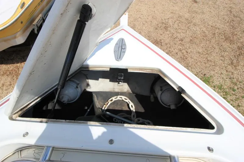 Slide: The Image of Open storage compartment on a 1997 Cobalt 272 BR boat, showing anchor chain inside. - 23