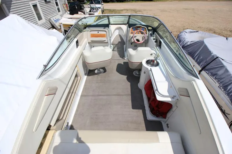 Slide: The Image of 1997 Cobalt 272 BR boat interior with seating, steering wheel, and storage compartments. - 27
