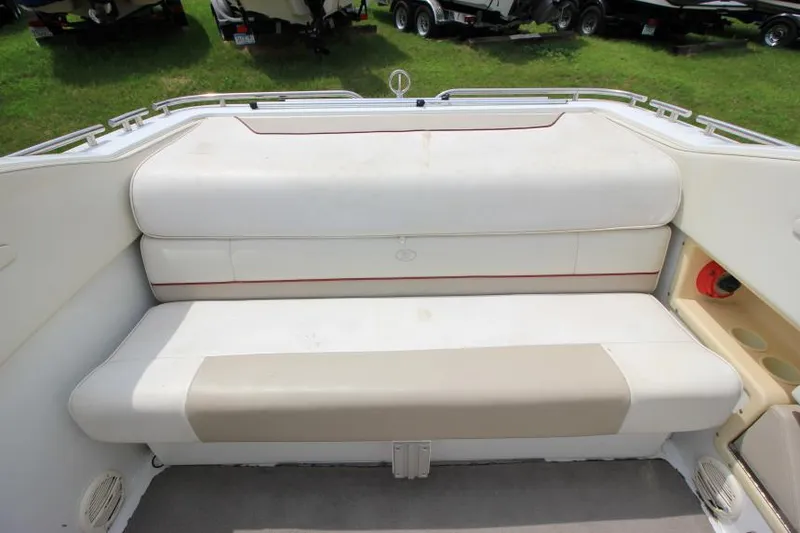 Slide: The Image of 1997 Cobalt 272 BR boat, rear view with red swim platform and propeller, parked outdoors. - 4