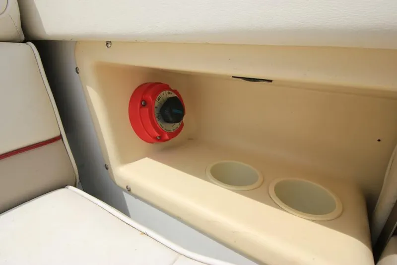 Slide: The Image of 1997 Cobalt 272 BR boat interior with red dial and cup holders. - 5