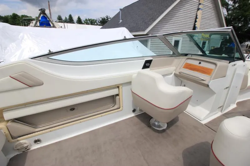 Slide: The Image of Interior of a 1997 Cobalt 272 BR boat, featuring white seating and dashboard. - 9