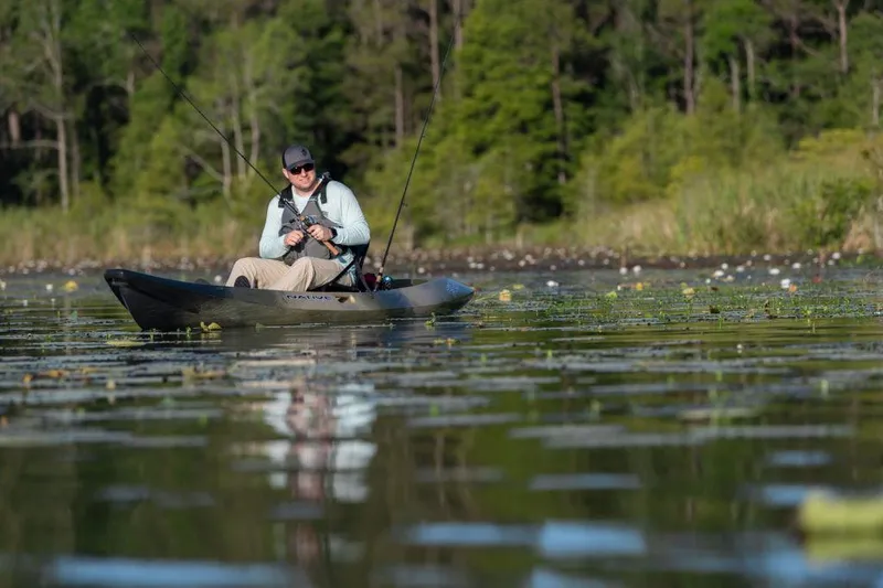 Slide: The Image of Man fishing on a lake in a 2022 Native Watercraft Stingray 11.5 kayak. - 3
