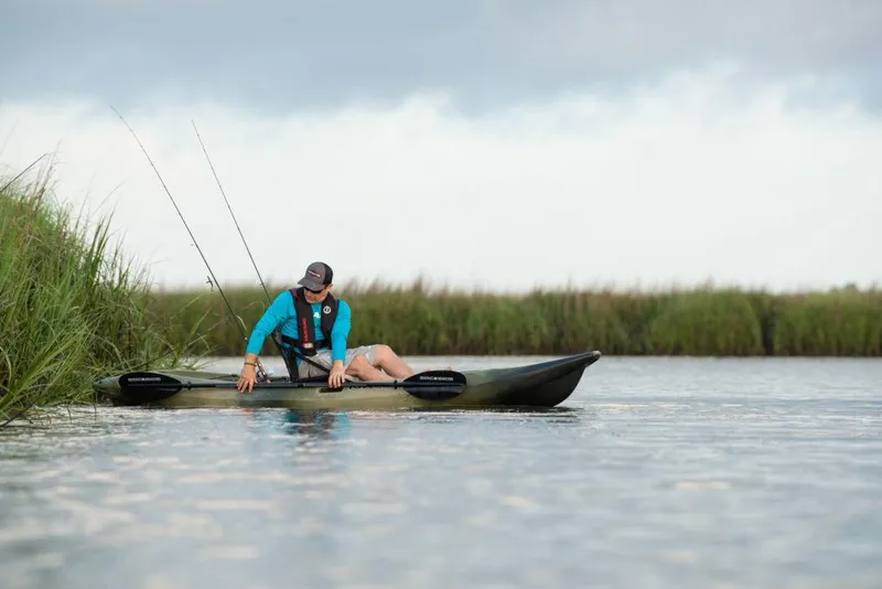 Slide: The Image of Person fishing from a 2022 Native Watercraft Stingray 11.5 kayak in a calm waterway. - 5