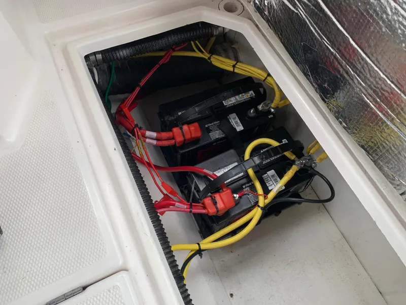 Slide: The Image of Battery compartment of a 2019 Cutwater C-28 boat with wiring. - 16