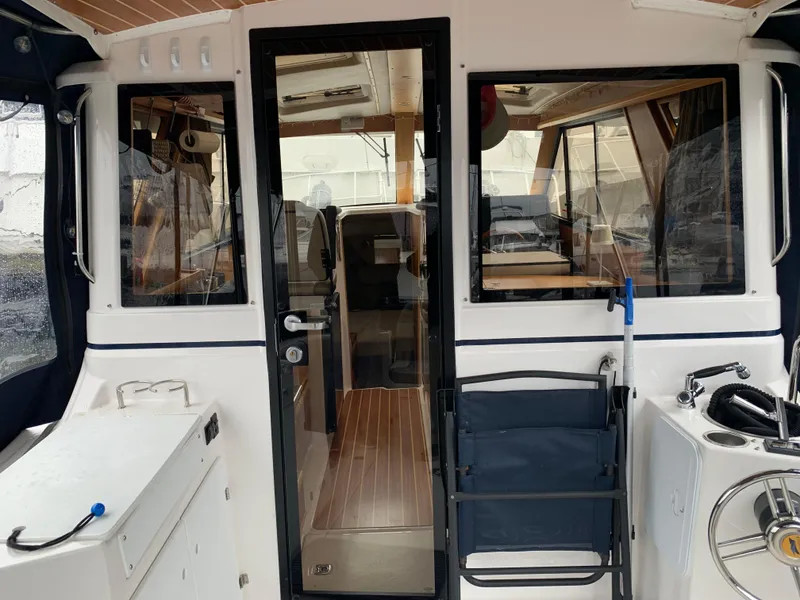 Slide: The Image of Interior view of a 2019 Cutwater C-28 boat with wooden flooring. - 2