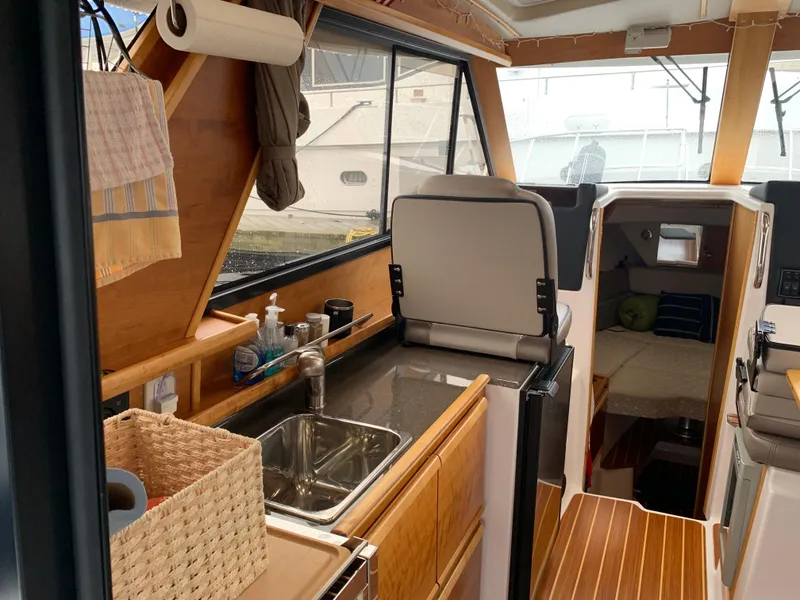 Slide: The Image of Interior of a 2019 Cutwater C-28 yacht with kitchen and sleeping area. - 7