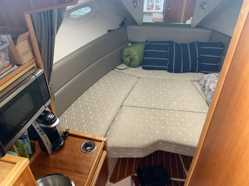 Slide: The Image of Interior of a 2019 Cutwater C-28 with cozy bed and kitchenette. - 8