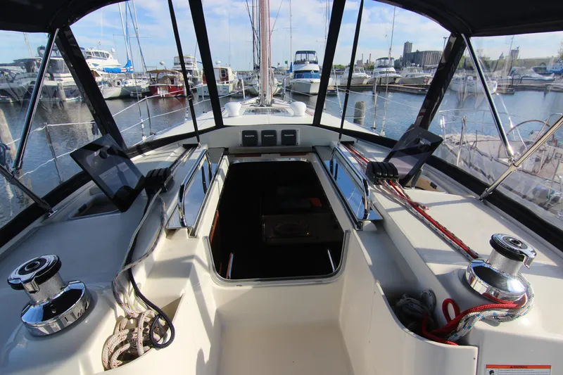 Slide: The Image of The cockpit of a 2015 Marlow-Hunter 37 with a steering wheel and marina view. - 9