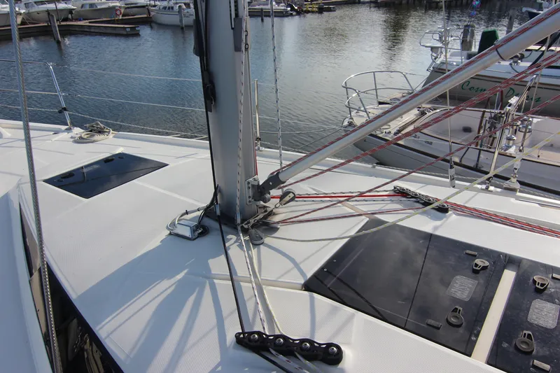 Slide: The Image of The deck of a 2015 Marlow-Hunter 37 with sailing equipment and a marina in the background. - 14