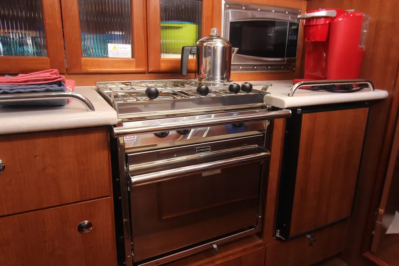 Slide: The Image of The galley of a 2015 Marlow-Hunter 37 with a stove, oven, and microwave. - 32