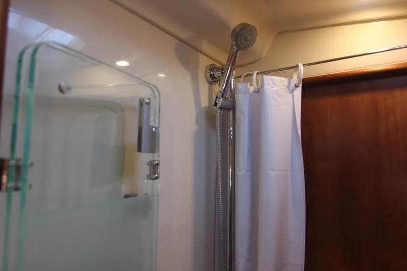 Slide: The Image of The shower in a yacht cabin with a showerhead and curtain. - 47