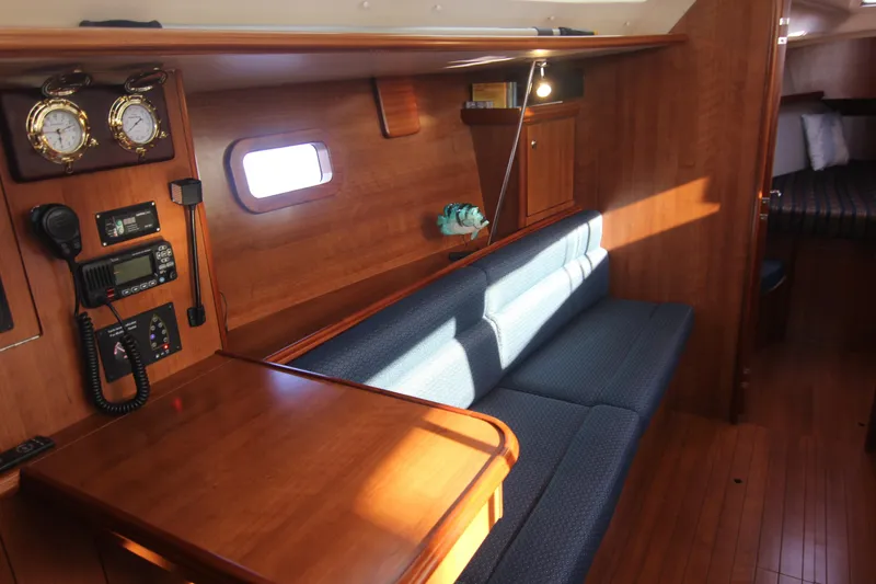 Slide: The Image of Interior of a 2015 Marlow-Hunter 37 with wooden furnishings and blue upholstery. - 39