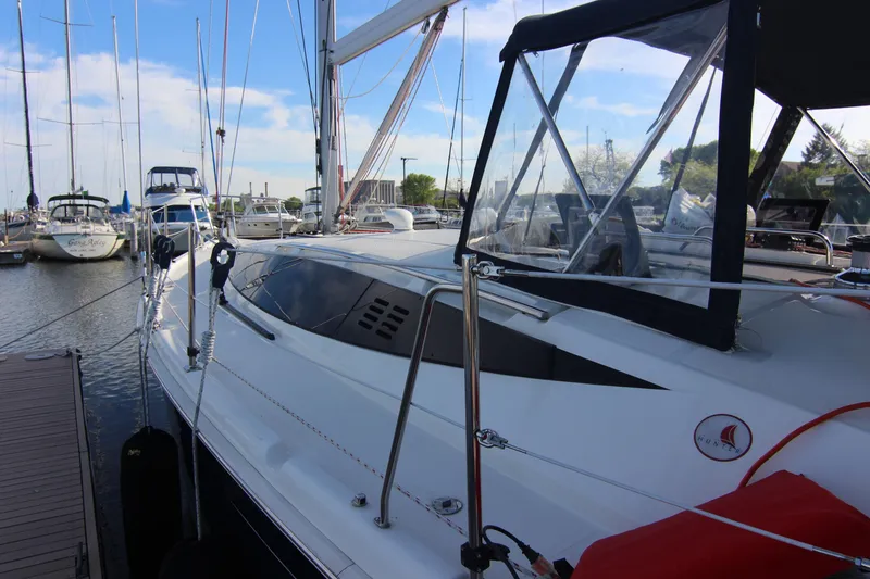 Slide: The Image of A 2015 Marlow-Hunter 37 sailboat docked. It features a sleek, modern design. - 2