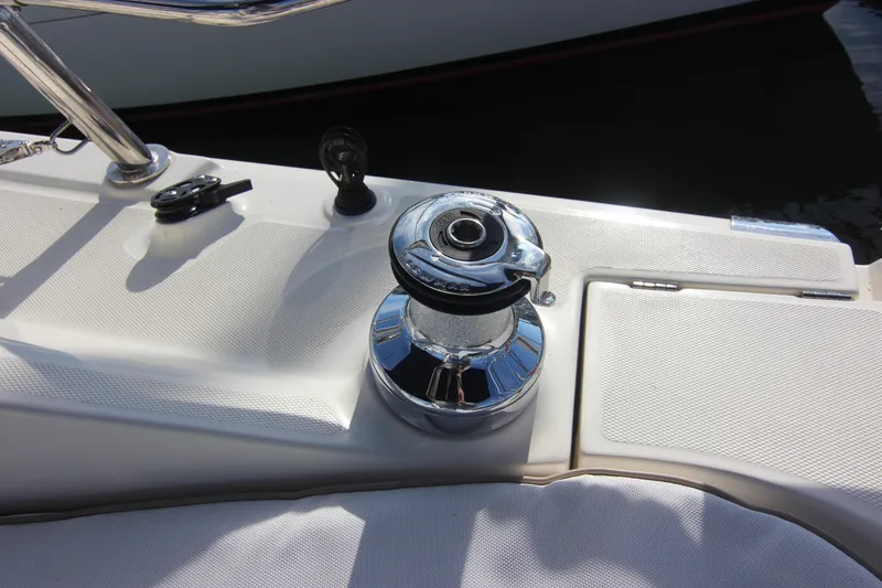 Slide: The Image of Close-up of a winch on a sailboat, surrounded by white upholstery and deck surface. - 7