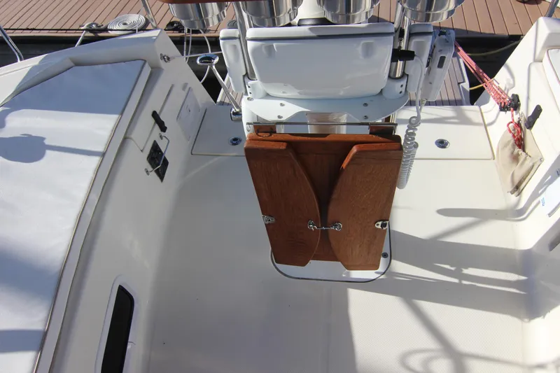 Slide: The Image of The cockpit of a 2015 Marlow-Hunter 37 with a wooden folding table and steering console. - 25