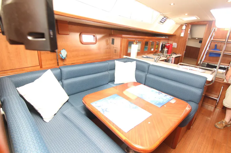 Slide: The Image of The interior of a 2015 Marlow-Hunter 37 features a cozy seating area with a wooden table. - 41