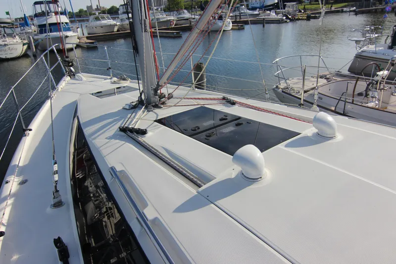 Slide: The Image of The deck of a 2015 Marlow-Hunter 37 in a marina, featuring sleek lines and modern details. - 18