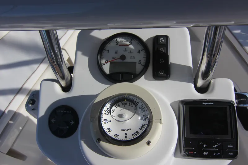 Slide: The Image of The image shows the helm of a 2015 Marlow-Hunter 37 with a compass and instruments. - 8