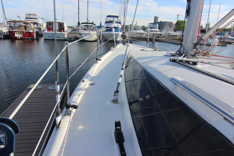 Slide: The Image of The deck of a 2015 Marlow-Hunter 37 in a marina, surrounded by other boats. - 17