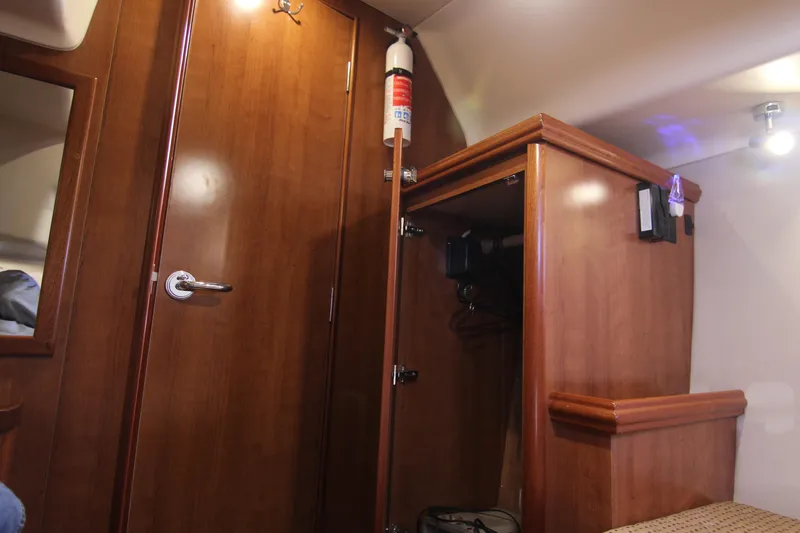 Slide: The Image of Interior of a 2015 Marlow-Hunter 37 with wooden furnishings and a fire extinguisher. - 46