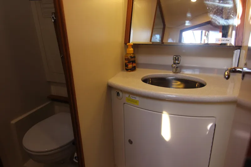 Slide: The Image of The image shows a boat bathroom with a sink, mirror, and toilet. - 48