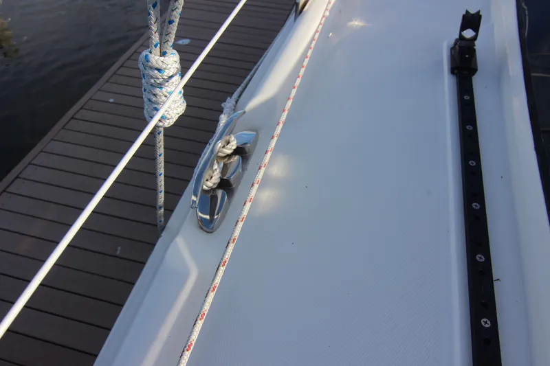 Slide: The Image of The image shows the deck of a 2015 Marlow-Hunter 37 with ropes and a dock. - 16