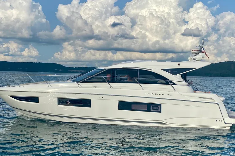 Slide: The Image of 2017 Jeanneau Leader 46 yacht cruising on a serene lake under a cloudy sky. - 47