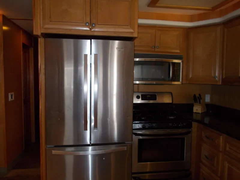 Slide: The Image of Modern kitchen with stainless steel appliances in a 2003 Stardust Cruisers houseboat. - 11