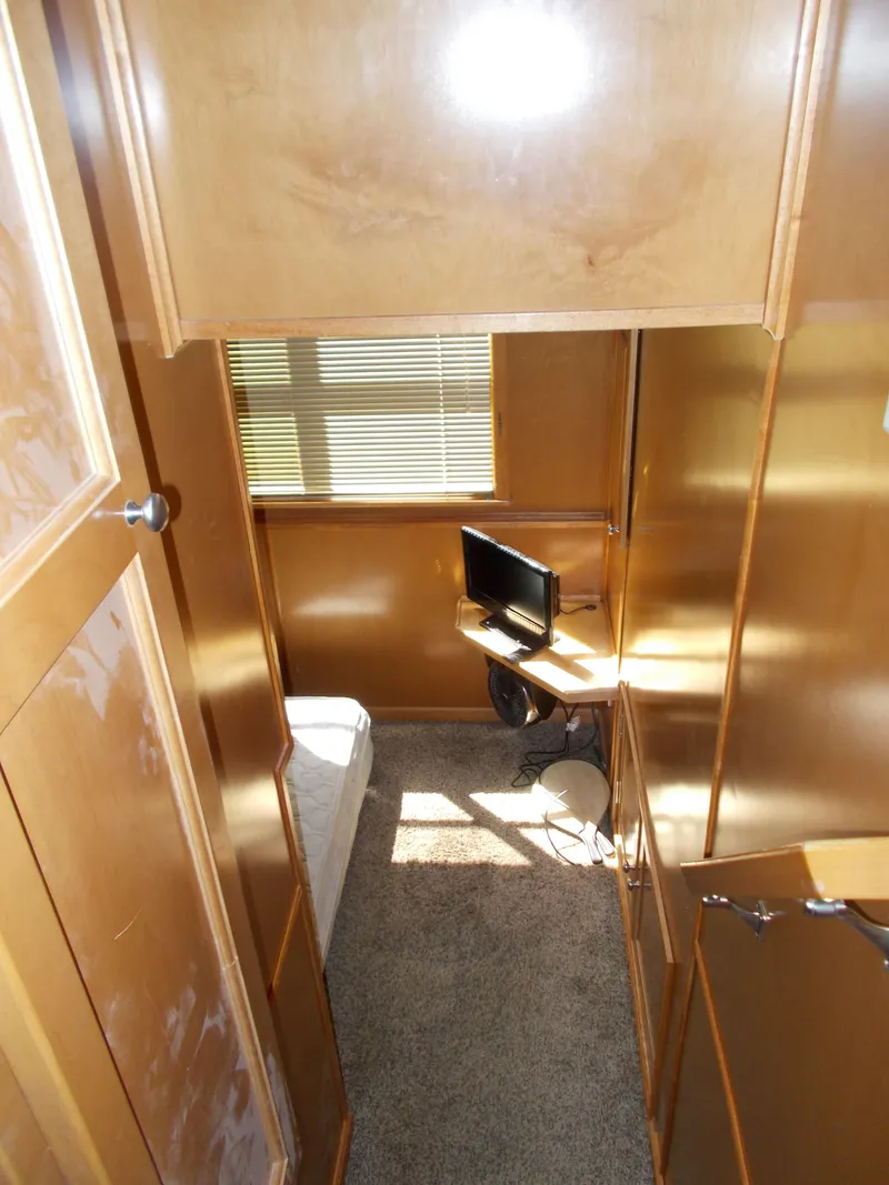 Slide: The Image of Interior of 2003 Stardust Cruisers For Shore 6, featuring a compact room with a small TV. - 12