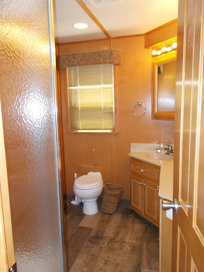 Slide: The Image of Bathroom interior of 2003 Stardust Cruisers For Shore 6 houseboat, featuring wood accents and modern fixtures. - 20