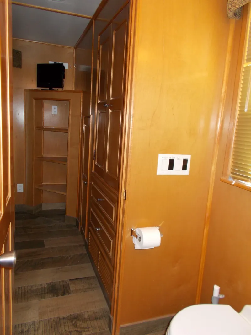 Slide: The Image of Interior of 2003 Stardust Cruisers houseboat with wooden cabinetry and modern amenities. - 23