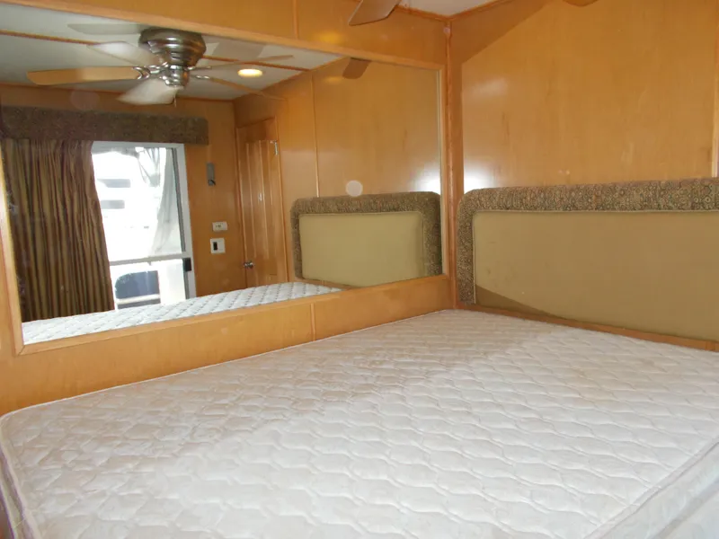 Slide: The Image of Bedroom interior of 2003 Stardust Cruisers For Shore 6 houseboat with mirror and ceiling fan. - 25