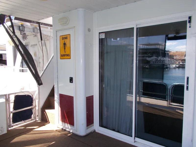 Slide: The Image of 2003 Stardust Cruisers For Shore 6, featuring sliding glass doors and a "Gone Surfing" sign. - 32