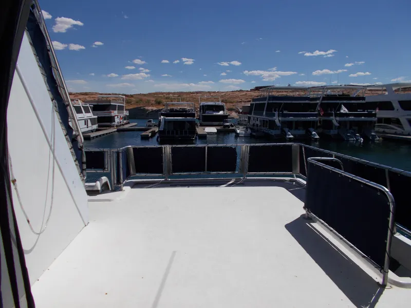 Slide: The Image of 2003 Stardust Cruisers For Shore 6 houseboat docked in a marina under a clear blue sky. - 34