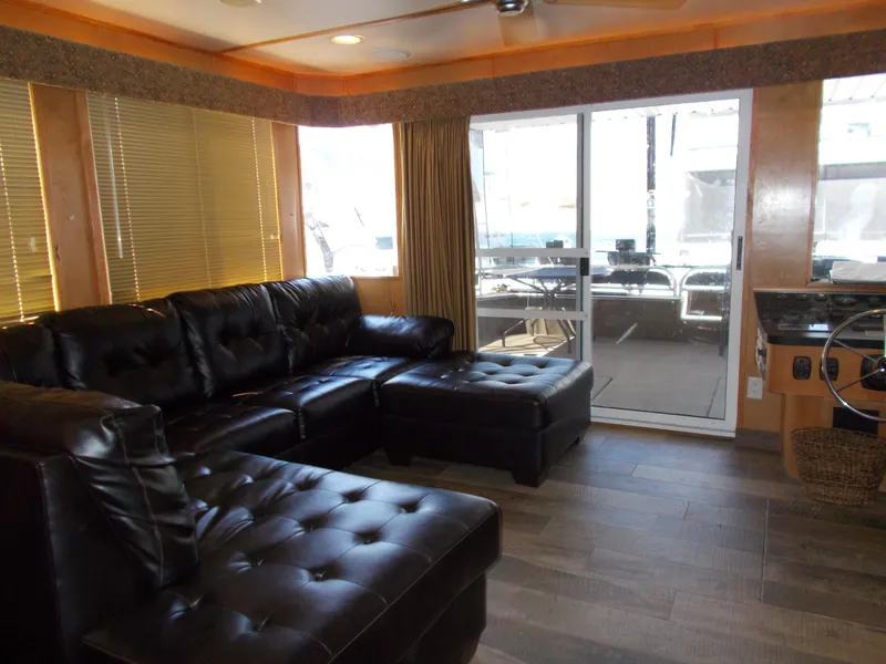 Slide: The Image of Luxurious 2003 Stardust Cruisers houseboat interior with leather seating and large windows. - 6