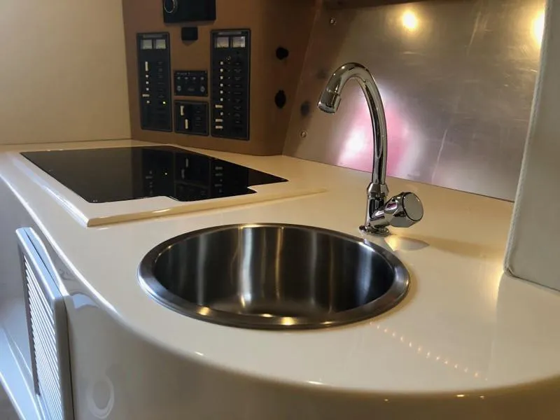 Slide: The Image of Modern kitchen area in 2025 Hustler 39 Shotgun boat with sink and stove. - 10