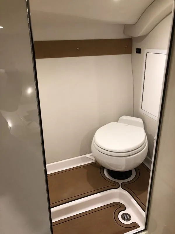 Slide: The Image of 2025 Hustler 39 Shotgun boat bathroom with modern design and compact toilet. - 11